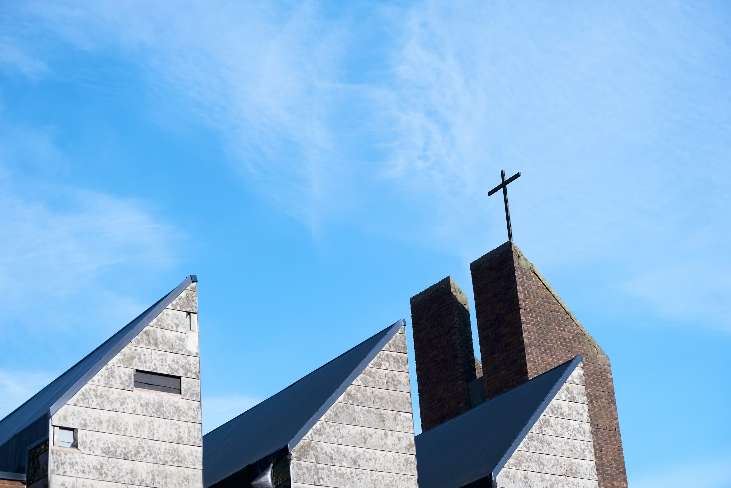 Modern church building with angular roofline and cross representing church and nonprofit organization financing