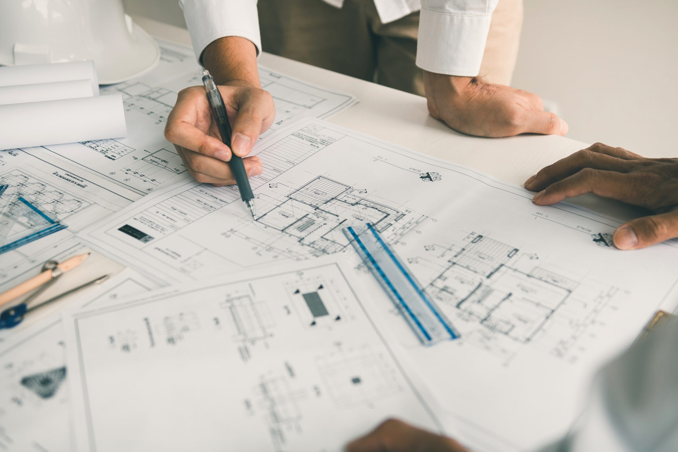 Two people reviewing building blueprints for a church or nonprofit facility project